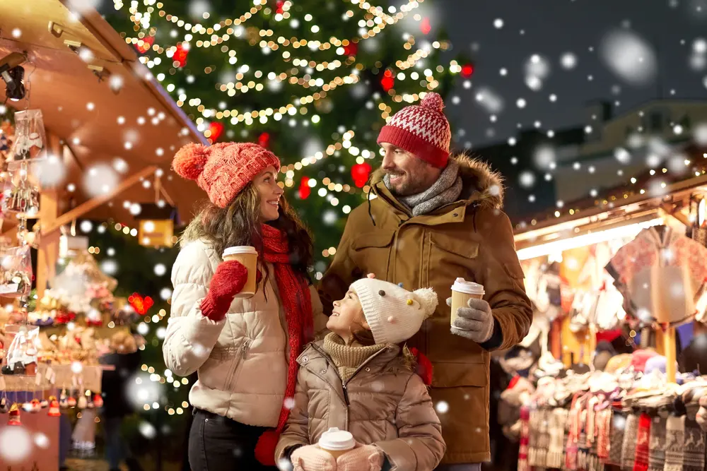 A family enjoying their trip to Christmas markets in Europe.
